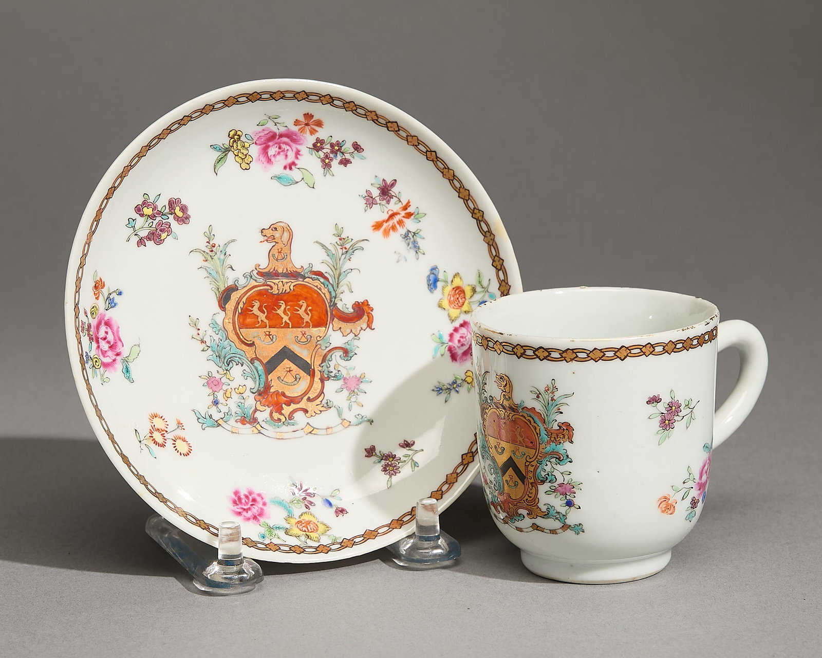Chinese Armorial Coffee Cup & Saucer - Henchman: Chinese export armorial porcelain coffee cup and saucer, Qianlong, ca. 1755. Each with the arms of Henchman with floral sprigs and a chain-link band along the rim. Thomas Henchman was a senior
