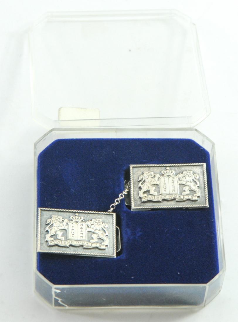 Pair of 925 sterling silver Tallit holders: Pair of 925 sterling silver Tallit holders, with reliefs of two lions, Tablets of Stone and the Hebrew inscription 'For from Zion Shall Come Forth Torah', signed, the actual clasp is not silver! In or