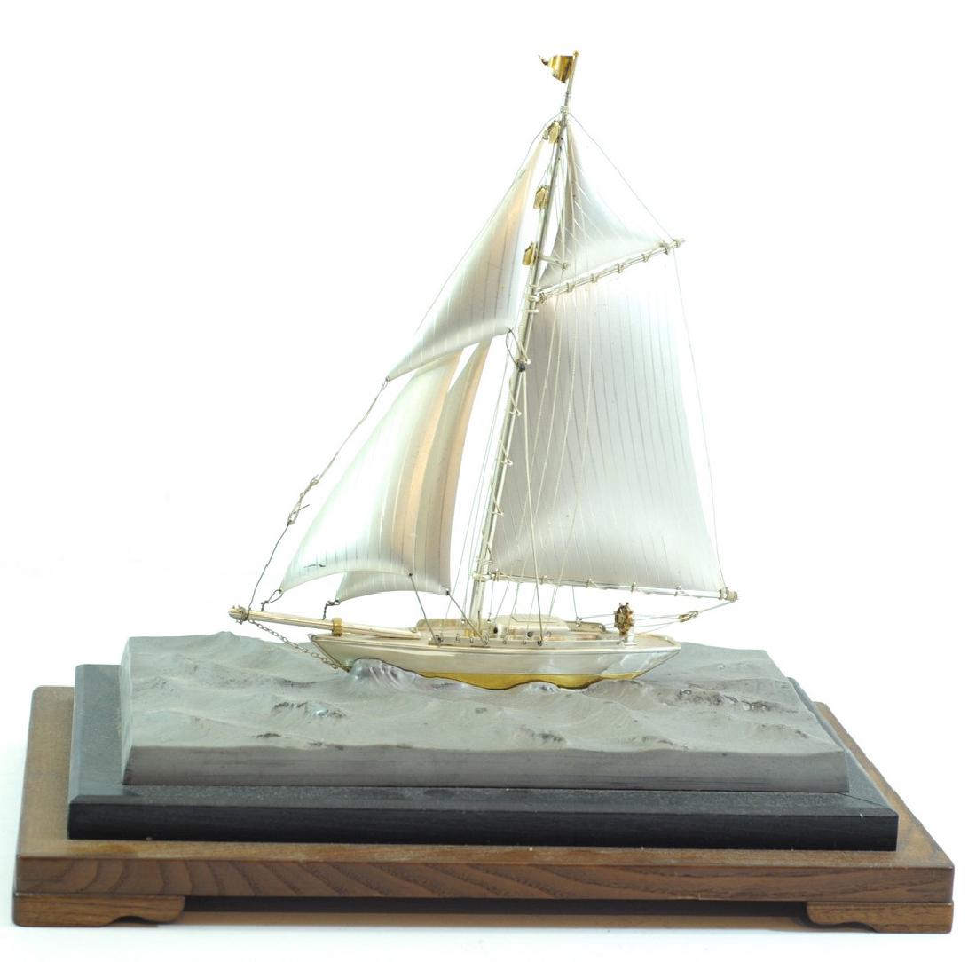 Ship, Japanese silver sculpture designed by Seki: Ship, Japanese silver sculpture designed by Seki Takehiko, mounted on a pewter and wooden base, signed, weight of silver estimated to be over 200 gm (based on similar sculptures), dimensions of base: