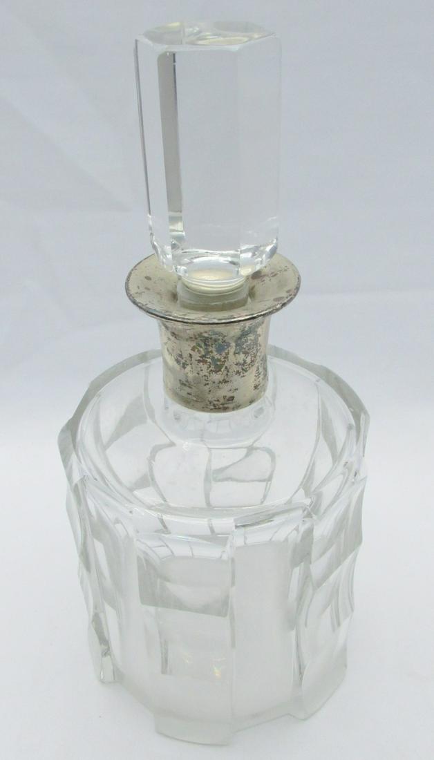 Hungarian Art Deco crystal and silver decanter bottle: Hungarian Art Deco crystal and silver decanter bottle, circa 1930s, handmade polished crystal glass with geometric patterns, applied silver clasp top, signed, height: 24 cm. Patina.
