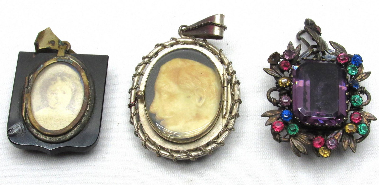 Assortment of 3 Antique Commemorative (Mourning) Pendants: Assortment of 3 Antique Commemorative (Mourning) Pendants, circa 1900, designed with a window to place hair or a memento in memory of a deceased loved one, which includes: 1. An oval metal pendant inl