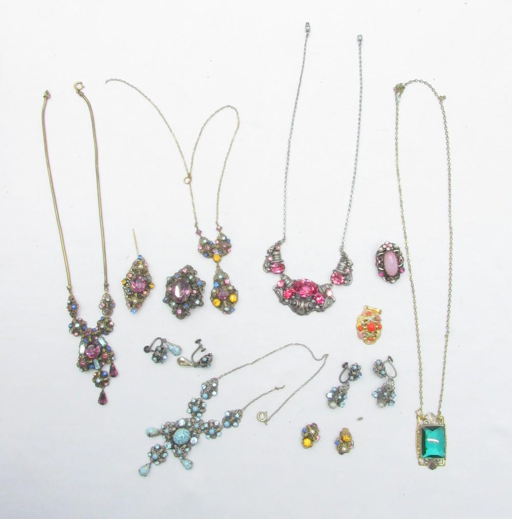 An Assortment Of 12 Fancy Austro-Hungarian Style Fashion Jewelry Pieces: An Assortment Of 12 Fancy Austro-Hungarian Style Fashion Jewelry Pieces, second half of the 20th century, made of metal and designed in faux-filigree crafting and inlaid with colored Paste Stones (gla