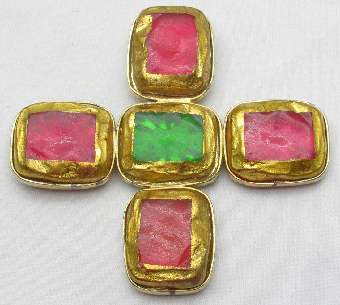 Grandiose fashion brooch-pendant made by Kenneth Lane: Grandiose fashion brooch-pendant made by Kenneth Lane, 1990s, designed in a cross pattern, made of gilded metal and inlay of acrylic stones (polymeric material) in red-green colors with gilding on the