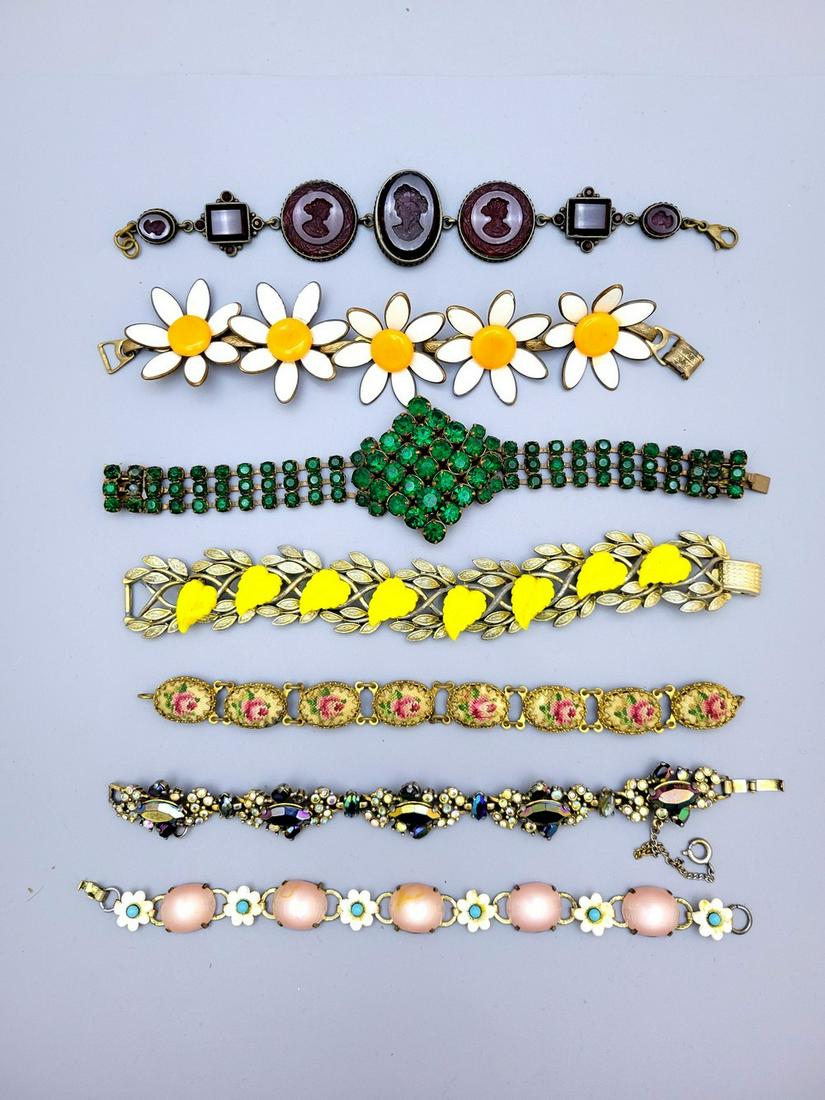An Assortment Of 7 Vintage Fashion Link Bracelets: An assortment of 7 vintage fashion link bracelets, 1950s-60s, including: 1. A bracelet made by Coro in the United States made of gilded leaf-shaped links and inlaid with leaf-shaped yellow glass beads