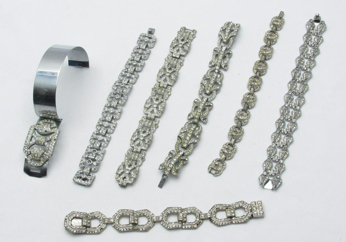 Assortment of 7 art deco fashion bracelets: Assortment of 7 art deco fashion bracelets, circa 1940s, made of silver metal and inlaid with transparent Paste Stones, of which 6 link bracelets and 1 Bangle bracelet, designed in various models and
