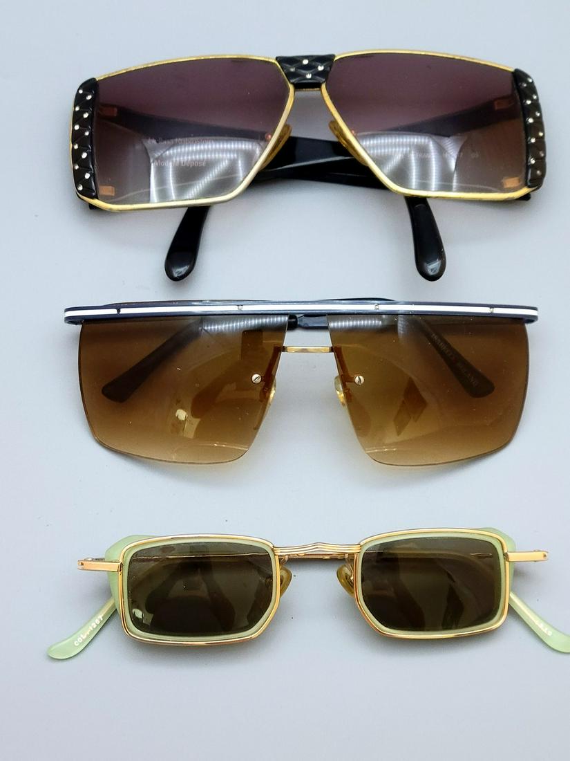 An Assortment Of 3 Pairs Of Vintage Fashionable Sunglasses: An assortment of 3 pairs of vintage fashionable sunglasses, circa 1980's, including a pair designed by Helena Rubinstein, a pair designed by Isabelle Roland and one additional pair. Light wear.