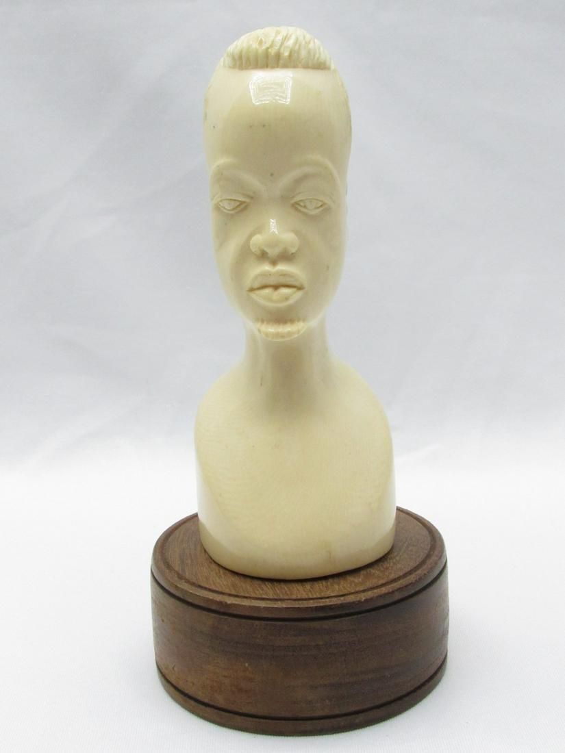 A high-quality African carved male bust figurine: A high-quality African carved male bust figurine, the second half of the 20th century, high-quality handcrafted carving out of a whole piece of elephant tusk, attached to a round wooden base, height: 