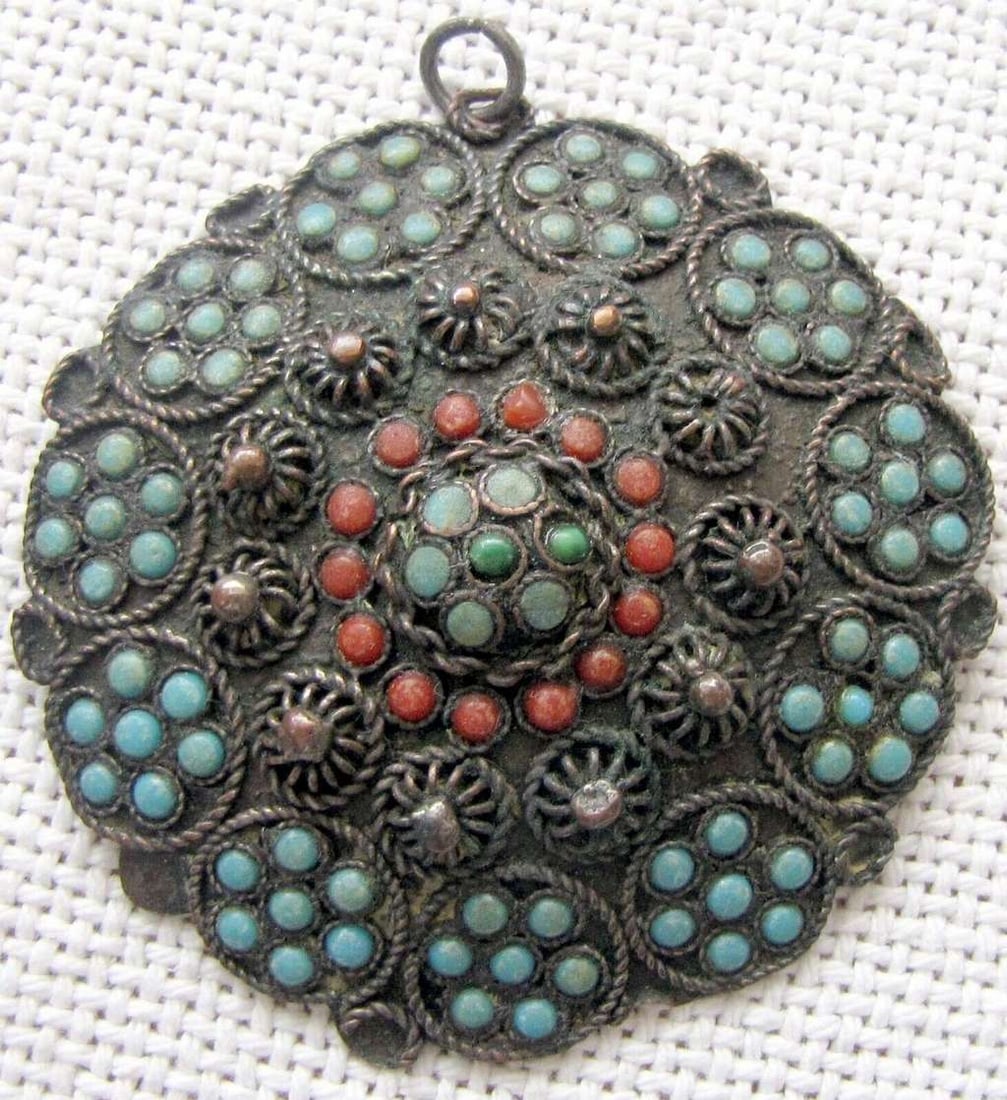 Tibet Nepal Buddhist antique filigree copper pendant set with turquoise and coral.: Tibet Nepal Buddhist antique filigree copper pendant set with turquoise and coral.Diameter: 6.2 cm. (2.4 inches)Hand crafted.Weight: 20gr.