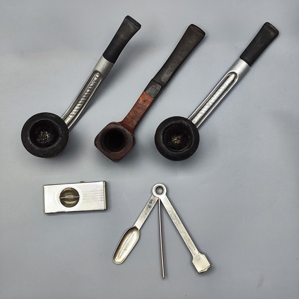 An assortment of smoking items: smoking pipes and cigarette butts (1 of 7)