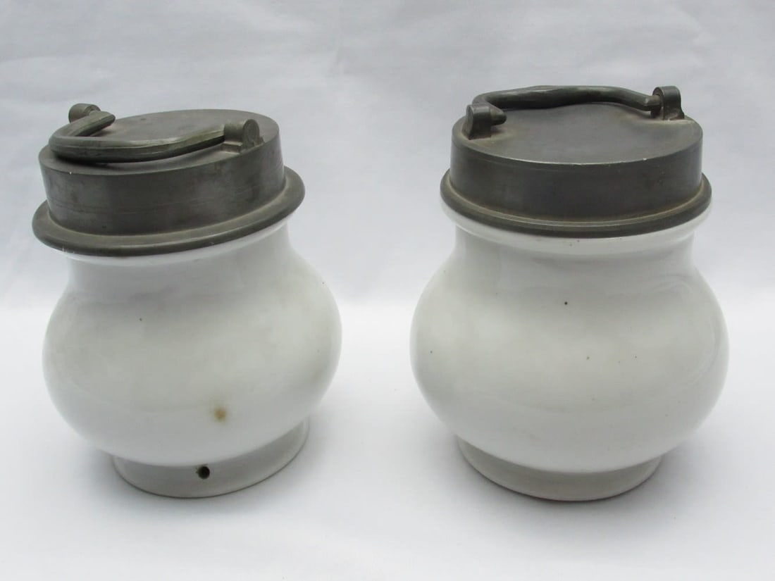 A Pair of Antique French Porcelain Medicinal Containers Soup Pots: A Pair of Antique Porcelain Medicinal Containers Soup Pots, France, 19th century, with screw-on pewter lids with a handle, one of the pots made by AL Paris is marked with the company name in the cente