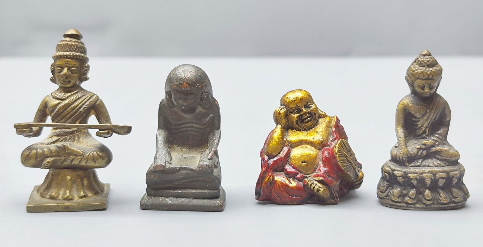 An assortment of 4 old/antique metal miniature Buddha figurines (1 of 5)