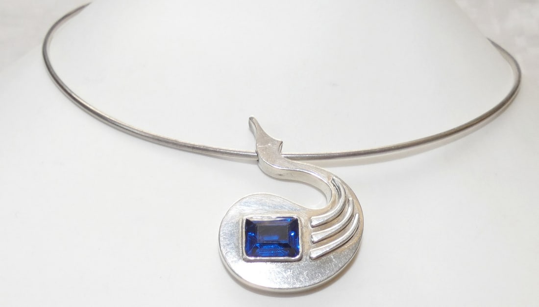 Vintage modernist silver sterling 925 Swan shaped collar necklace set with faceted sapphire, 17 gr.: Vintage modernist silver sterling 925 Swan shaped collar necklace set with faceted sapphire, 17 gr. HAND CRAFTED. HAMMERED MARKED 925 SIZE OF PENDANT: 3.7 x 2.8 cm. (1.4 x 1.1 inches) FLEXIBLE WIDTH (