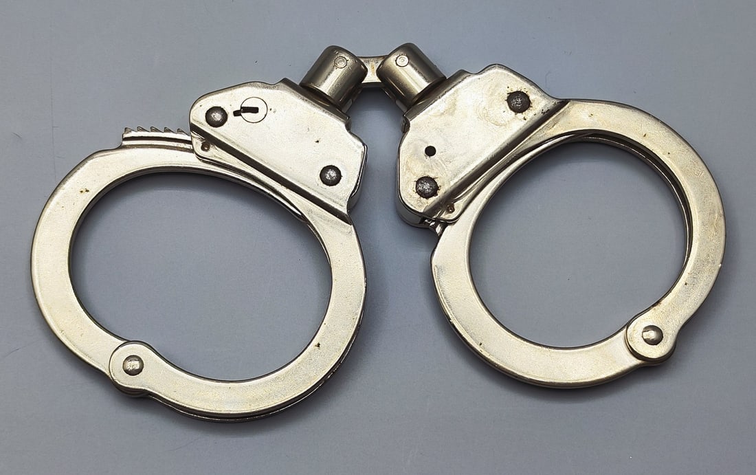 A pair of metal handcuffs made by Fury Spain, model 15900. (1 of 4)