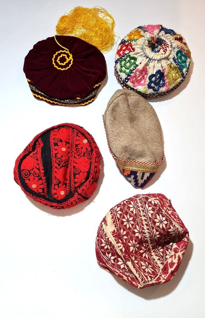 An assortment of 5 hats/Kippahs Bukhara/Balkan countries: An assortment of 5 hats/Kippahs Bukhara/Balkan countries, second half of the 20th century, various fabrics: cotton, velvet and wool, decorated with high-quality handcrafted embroidery with various pat