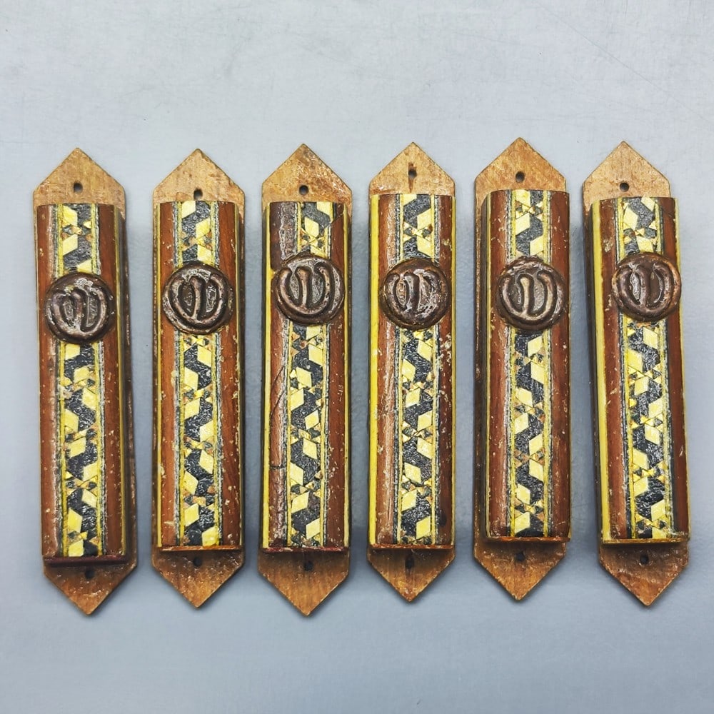Rare! An assortment of 5 wooden mezuzah cases designed by the "Apadana-Eilat" workshop: Rare! An assortment of 5 wooden mezuzah cases designed by the "Apadana-Eilat", apparently a private family workshop, circa 1960s, decorated on the front side with colorful parquetrie crafting and a ro
