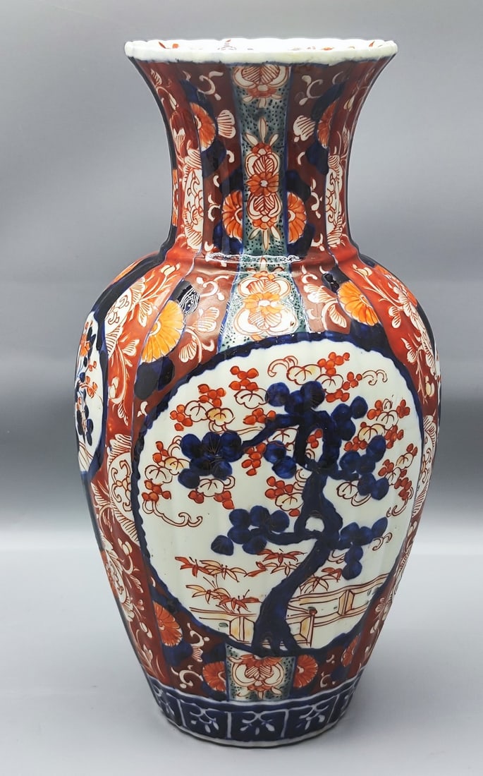 Antique Japanese Imari Porcelain Vase: Antique Japanese Imari porcelain vase, circa 1900, decorated with typical hand-painting in blue and red on a grayish glaze background with a pattern of typical flowers and plants, height: 30 cm, maxim