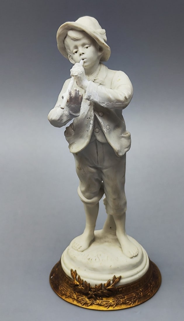 Antique bisque porcelain "flutist" figurine made in Sevres: Antique bisque porcelain "flutist" figurine made in Sevres, 19th century, combined with a brass base decorated with plant decorations and gilded, signed by the modalist artist and designer on top of t