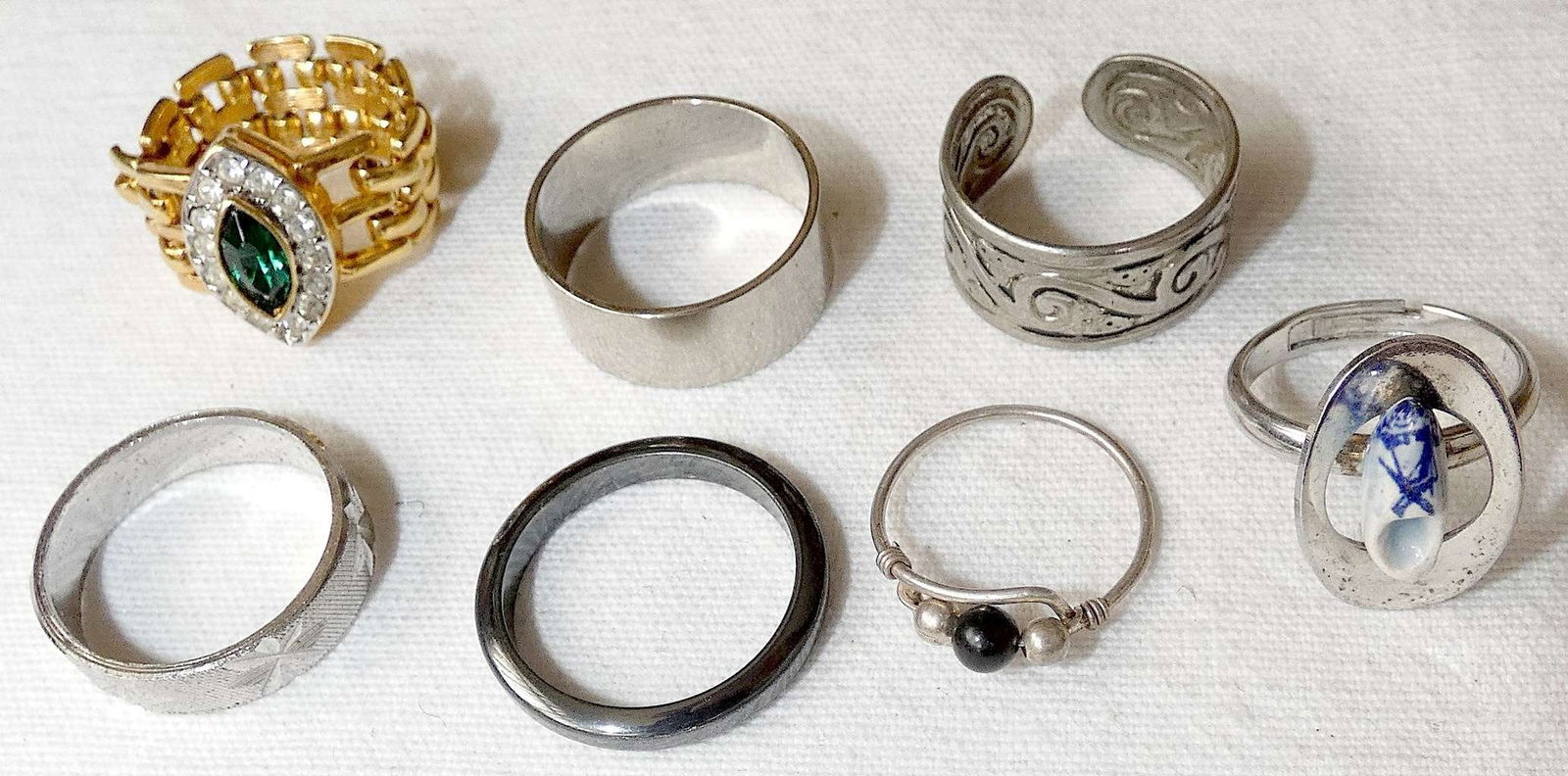 Lot of 7 vintage rings.: Lot of 7 vintage rings. Gold tone chain ring set with Swarovski crystal, size: 7.5 Dutch silver tone ring with porcelain shoe, size: 6.75 Hematite band ring, size: 10 Engraved silver tone band ring, s