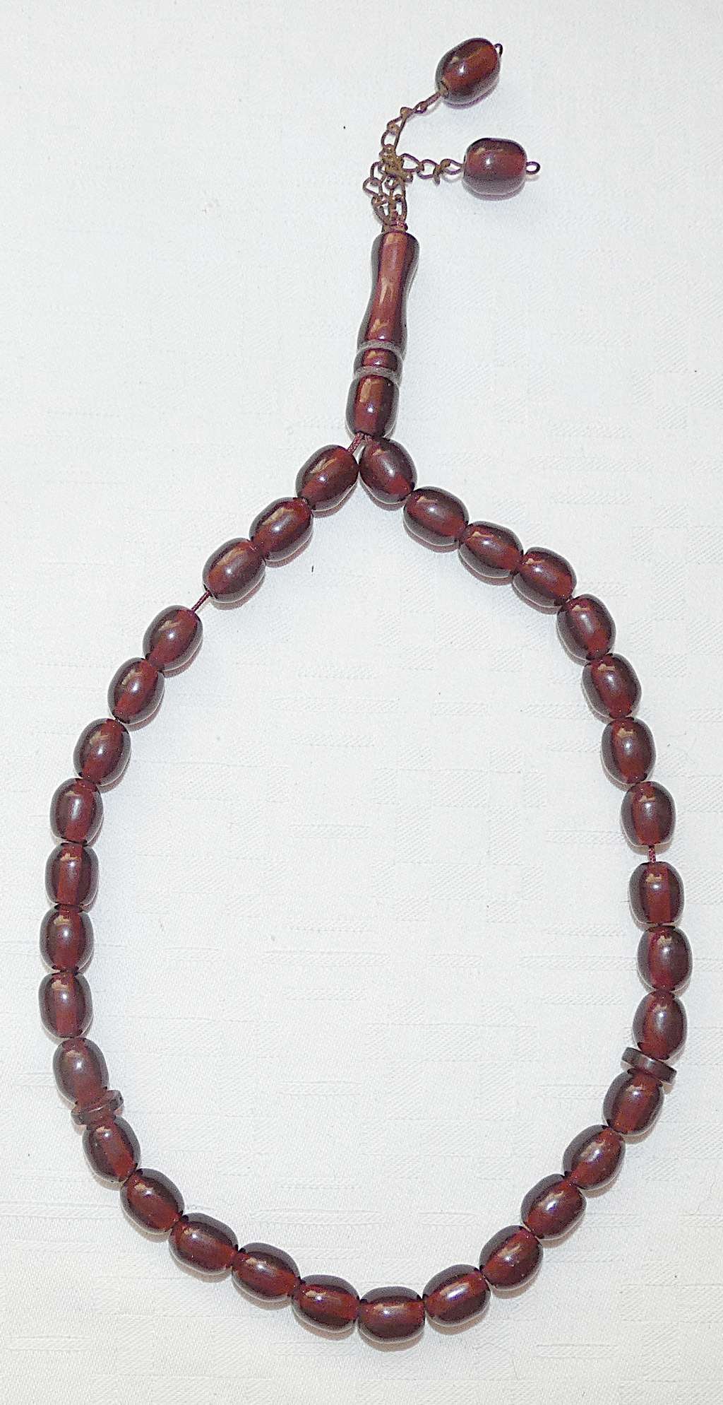Islamic Antique Carved Cherry Faturan 33 Prayer Beads Misbaha: Islamic Antique Carved Cherry Faturan 33 Prayer Beads Misbaha Size of bead: 9 x12 mm. Weight: 31 gr. Faturan, in Middle Eastern beadwork, is a material used to make beads, notably in the making of kom