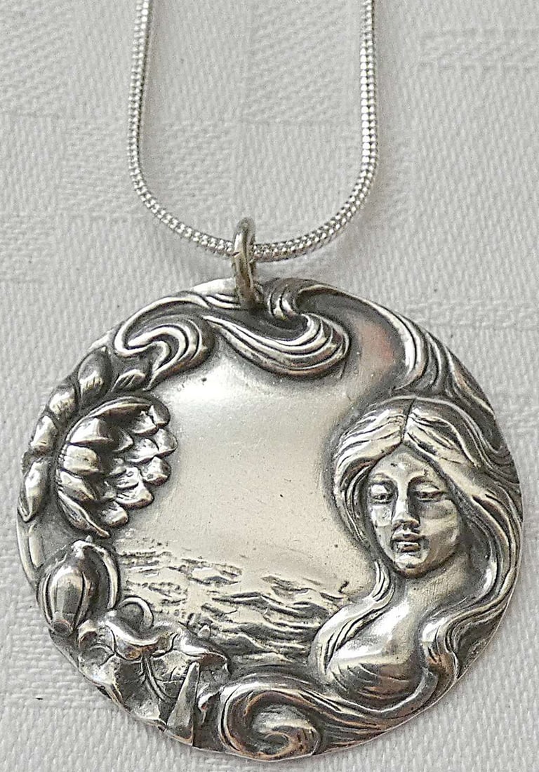 Art Nouveau Repousse Engraved Silver Plated Pendant Necklace: Art Nouveau Repousse Engraved Silver Plated Pendant Necklace Diameter: 2.8 cm. (1.1 inches) Length of silver chain: 50.6 cm. (20 inches)