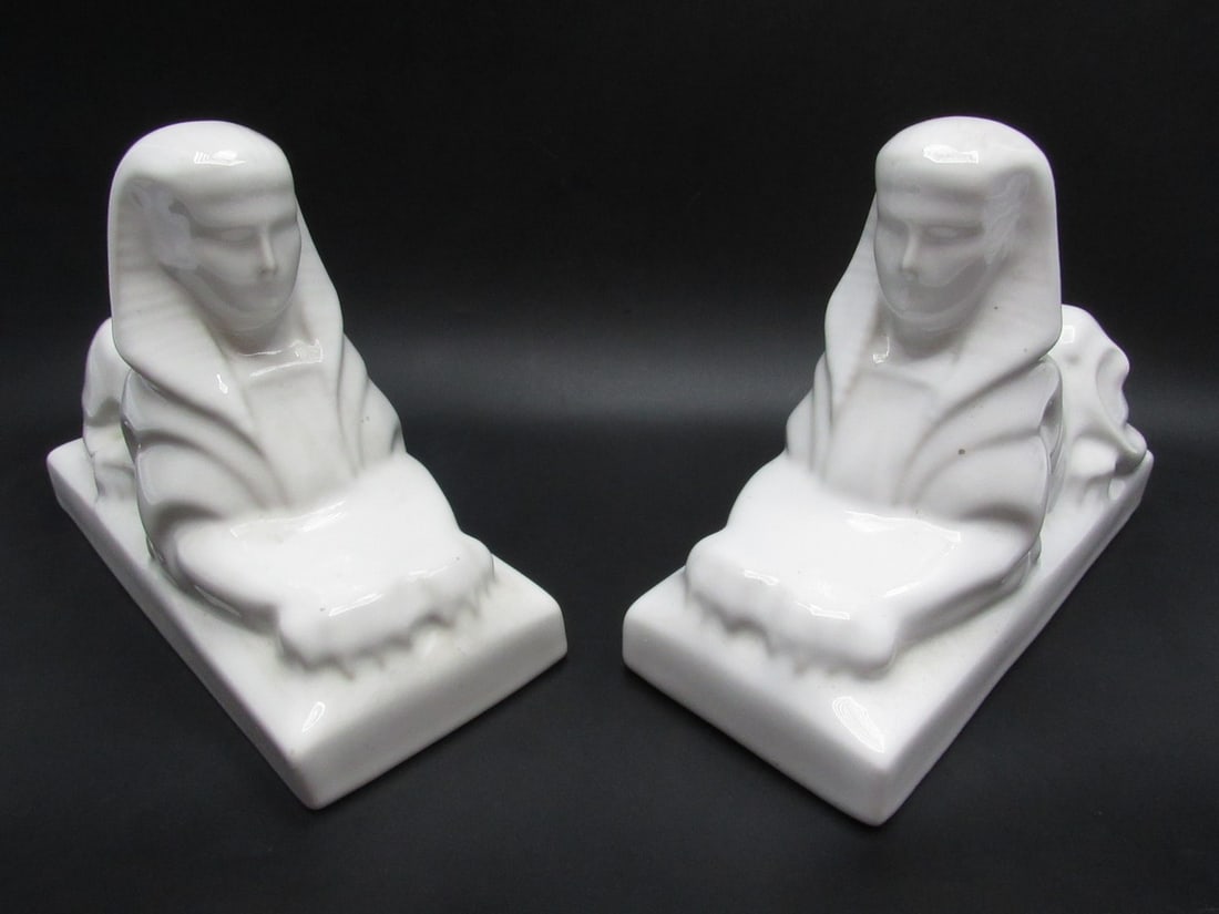 Pair of White Ceramic Sphinx Egyptian Revival Bookends: Pair of White Ceramic Sphinx Egyptian Revival Bookends, circa 1920s-30s. White glaze. Width: 20 cm. Height: 14.5 cm.