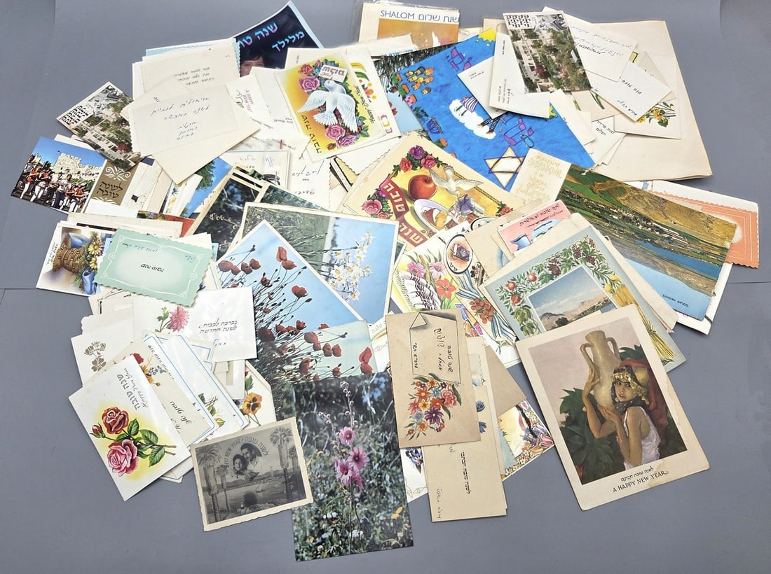 Large Assortment of Israeli "Shana Tova" Greeting Cards: Approx. 790 g of postcards from the 1950s–70s. Includes themes of Israel landscapes, flowers, and Jewish symbols. Many are postally used with handwritten blessings. Housed in a shoe box.