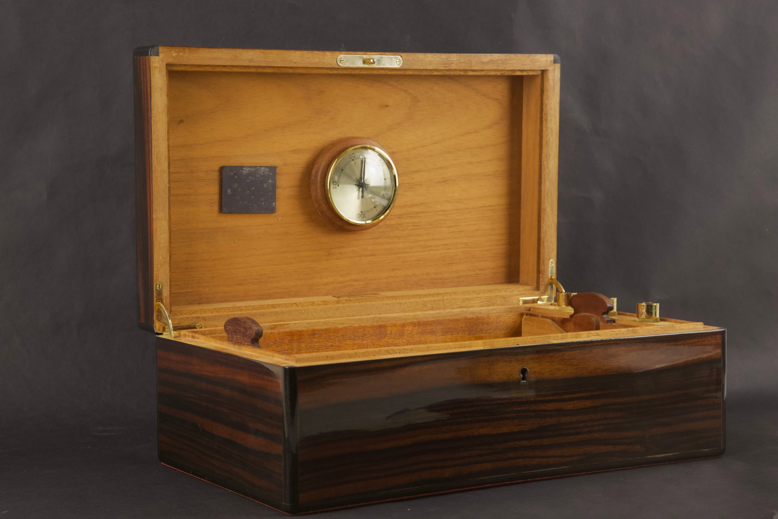 Circa 1980s Daniel Marshall For Alfred Dunhill Wood Cigar Humidor Box With Accessories: Title: Circa 1980s Daniel Marshall For Alfred Dunhill Wood Cigar Humidor Box With Accessories Medium: Wood / Veneer / Brass Size: 9." H x 5.75" W x 15.63" L Condition: Good vintage condition with wear