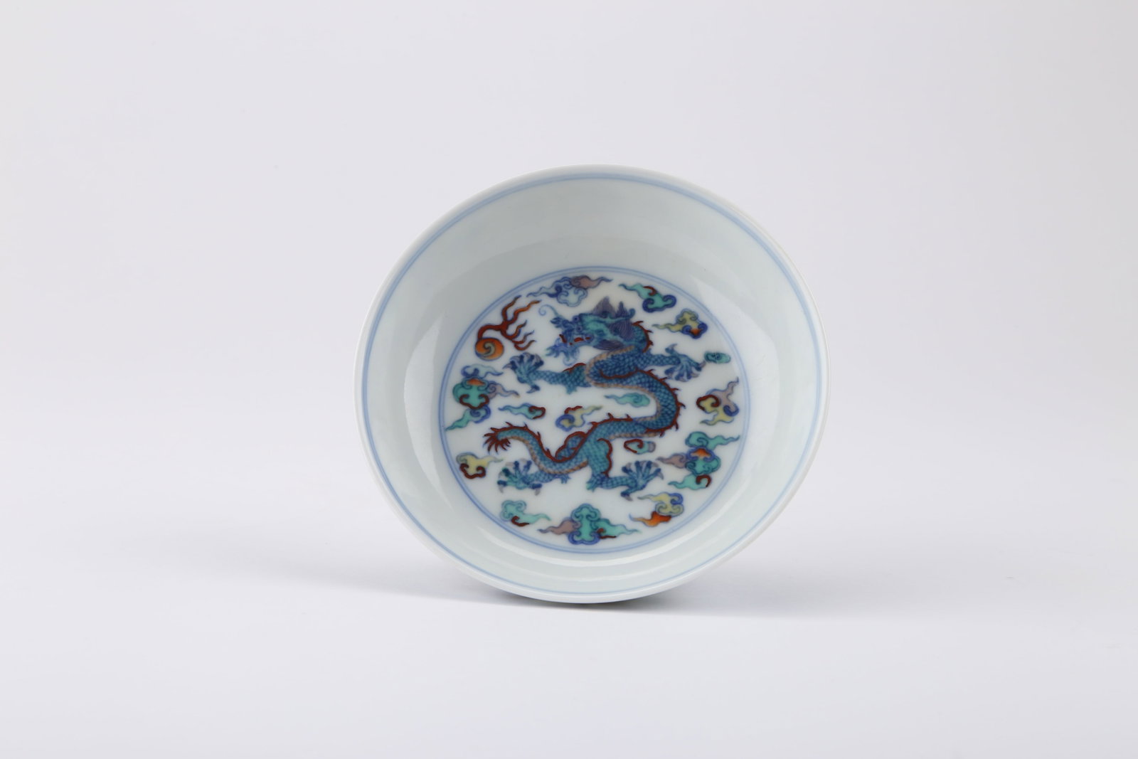 Qing Qianlong Doucai Dragon Motif Dish: QING QIANLONG DOUCAI DRAGON MOTIF DISH Dimensions: Overall size: Height: 3 cm, Diameter: 11.6 cm. All measured values are approximate. Description: The lot takes the form of a dish, using doucai surfa