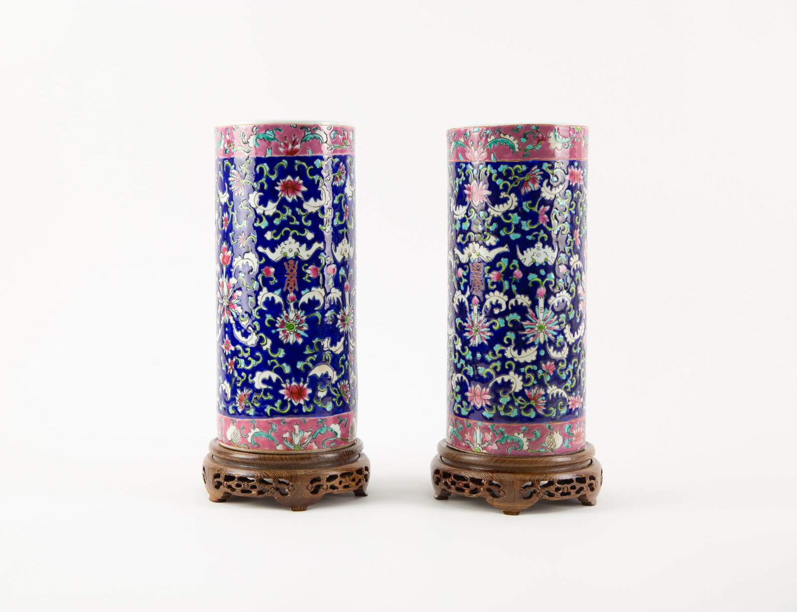 Pair of Chinese Famille Rose Floral Scroll Porcelain Brush Pots with Wooden Stands.: Size: H 11 x L 5 x W inches Condition: Good overall condition for its age. Shipping: shipping rates are determined by the distance from the auction site. C0004 Bidders need to know All the items are s