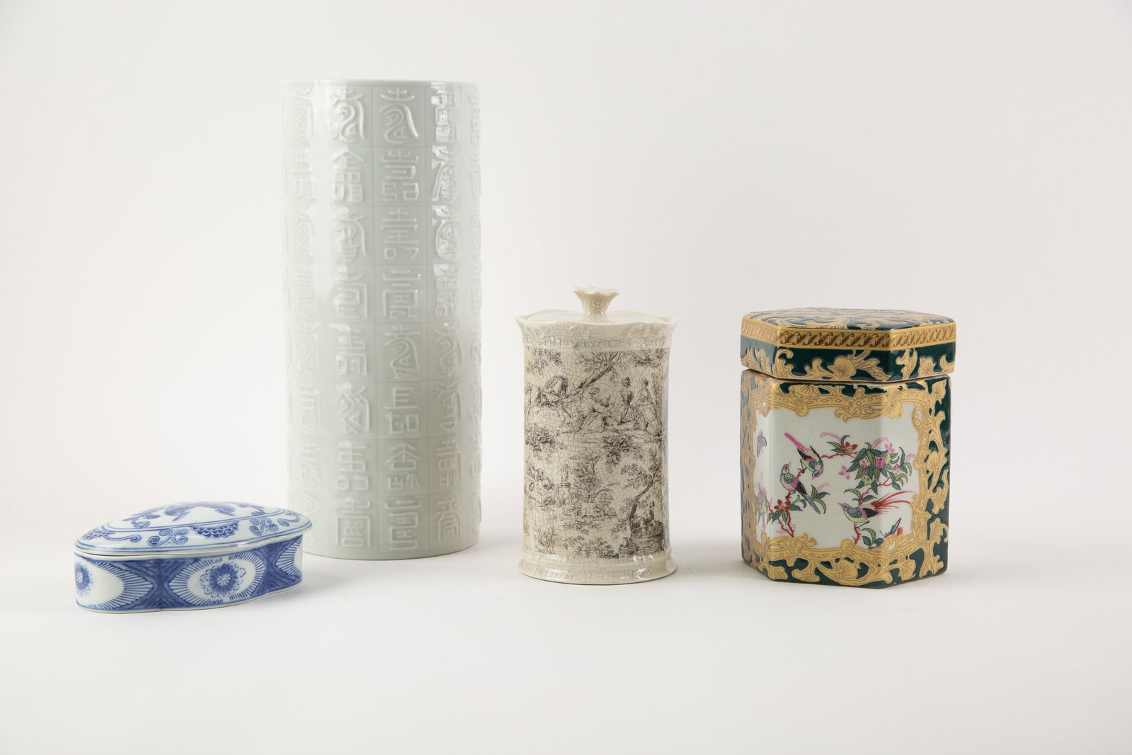 Group of four porcelain Decorative objects,Including a Blue and White Covered Box,an Archaistic: Size: H x L 12 x W 5 inches Condition: Good overall condition for its age. Shipping: shipping rates are determined by the distance from the auction site. C0007 Bidders need to know All the items are