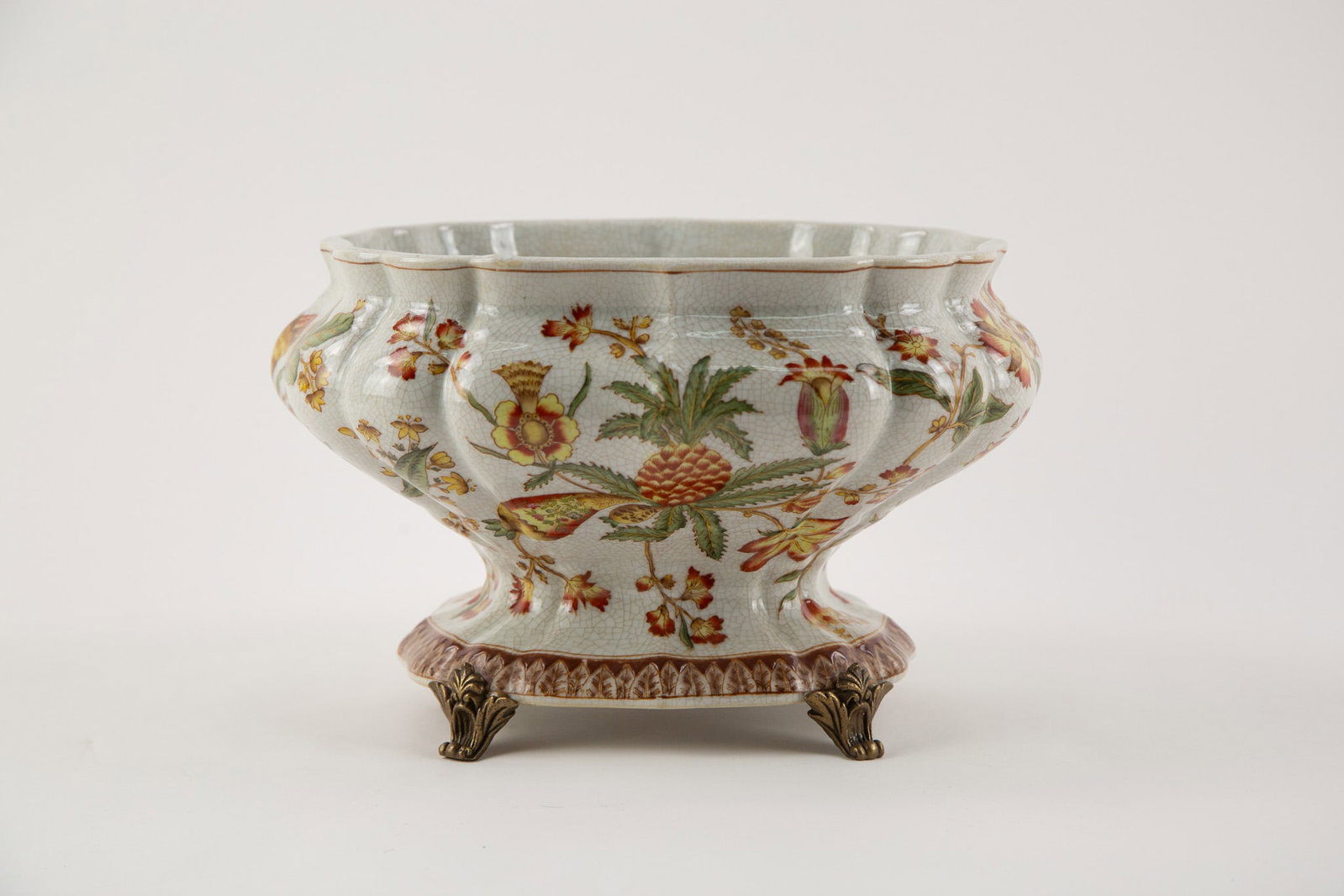 Chinese-Style porcelain planter,Decorated with Exotic Floral Motifs, Raised on Metal Feet. Not For: Size: H x L 10 x W 7.5 inches Condition: Good overall condition for its age. Shipping: shipping rates are determined by the distance from the auction site. C0008 Bidders need to know All the items