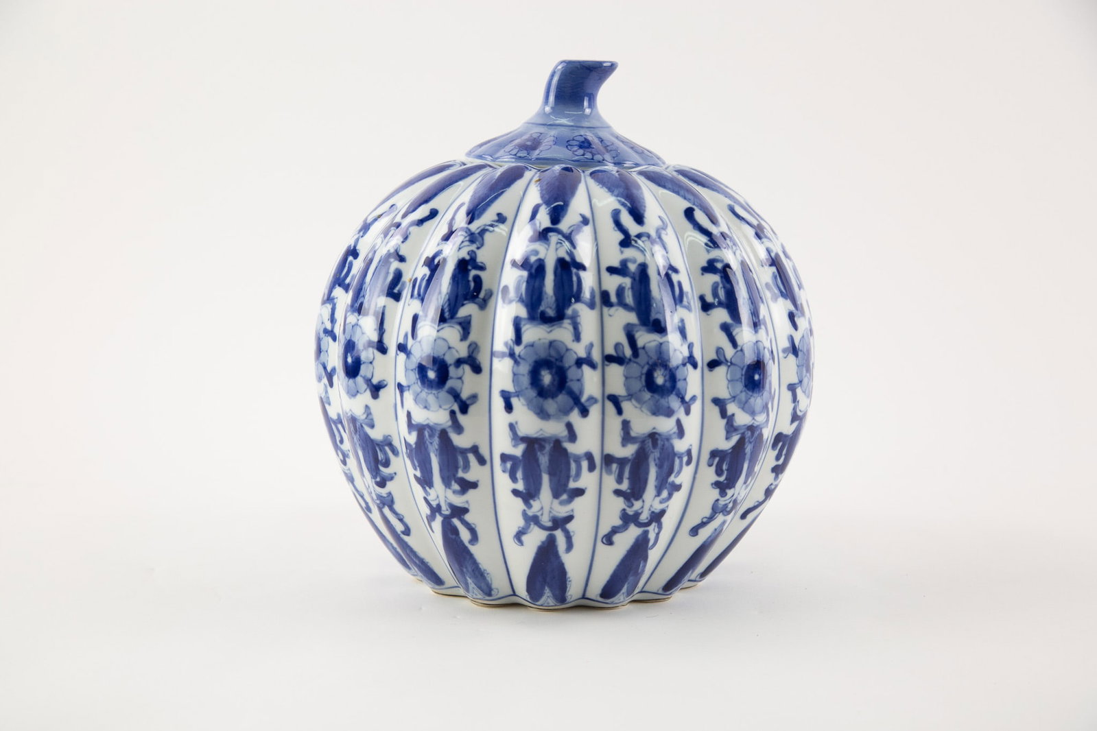 Chinese Blue and White ribbed Porcelain Vase,decorated with floral and foliate motifs,the globular: Size: H x L 11 x W 9 inches Condition: Good overall condition for its age. Shipping: shipping rates are determined by the distance from the auction site. C0009 Bidders need to know All the items are