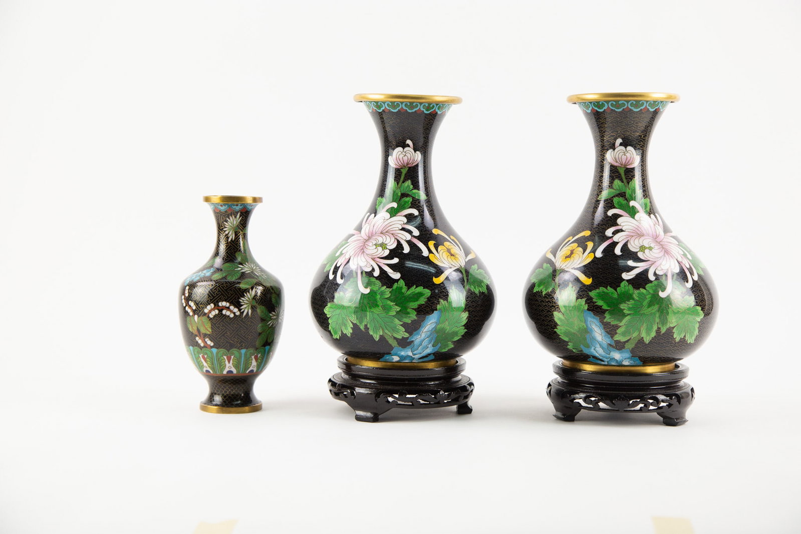 Group of three Cloisonne Vases,Iincluding a Pair.: Size: H x L 10 x W 6 inches Condition: Good overall condition for its age. Shipping: shipping rates are determined by the distance from the auction site. C0012 Bidders need to know All the items are