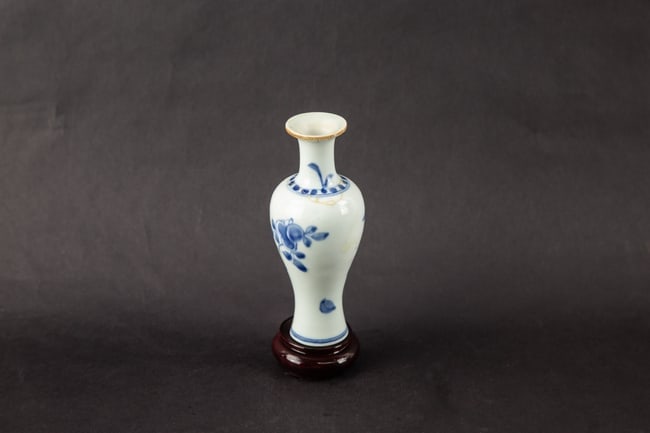 Asian Blue & White Porcelain Miniature Vase With Floral Decoration: Title: Asian Blue & White Porcelain Miniature Vase With Floral Decoration Medium: Chinese Ceramic Size: 6.75" H x 2.25" W x 2.25" L Condition: Fair to good vintage condition with visible wear consiste