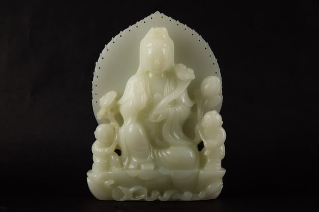 Asian Carved Hardstone Guanyin Figure With Child Attendants: Title: Asian Carved Hardstone Guanyin Figure With Child Attendants Medium: Carved Hardstone Size: 8.5" H x 2." W x 6.25" L Condition: Good vintage condition with wear consistent with age and use. Mino