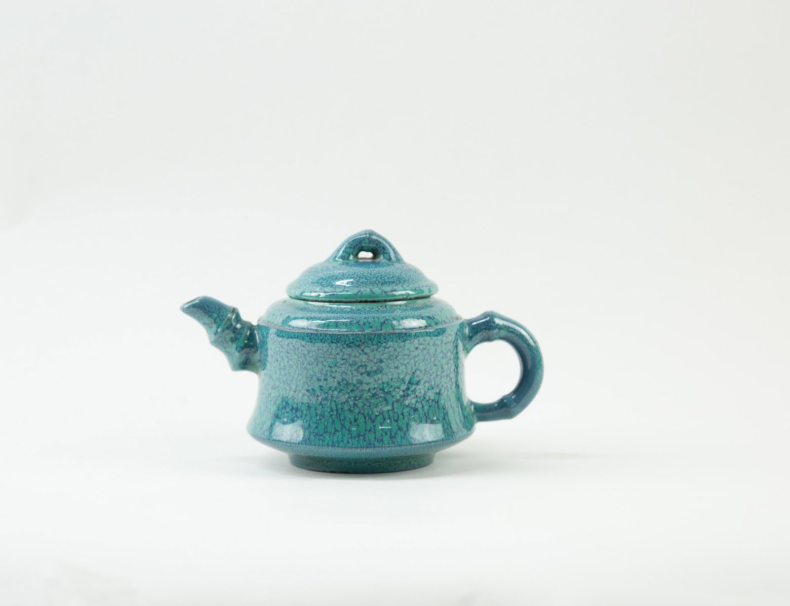 Zisha Teapot with Jun Glaze: Item Size: 4 x 4.5 x 6.5 inches Condition: This item is in great condition for its age. Jun-glazed Zisha ware is a low-fired transmutation glaze developed during the Yongzheng period of the Qing