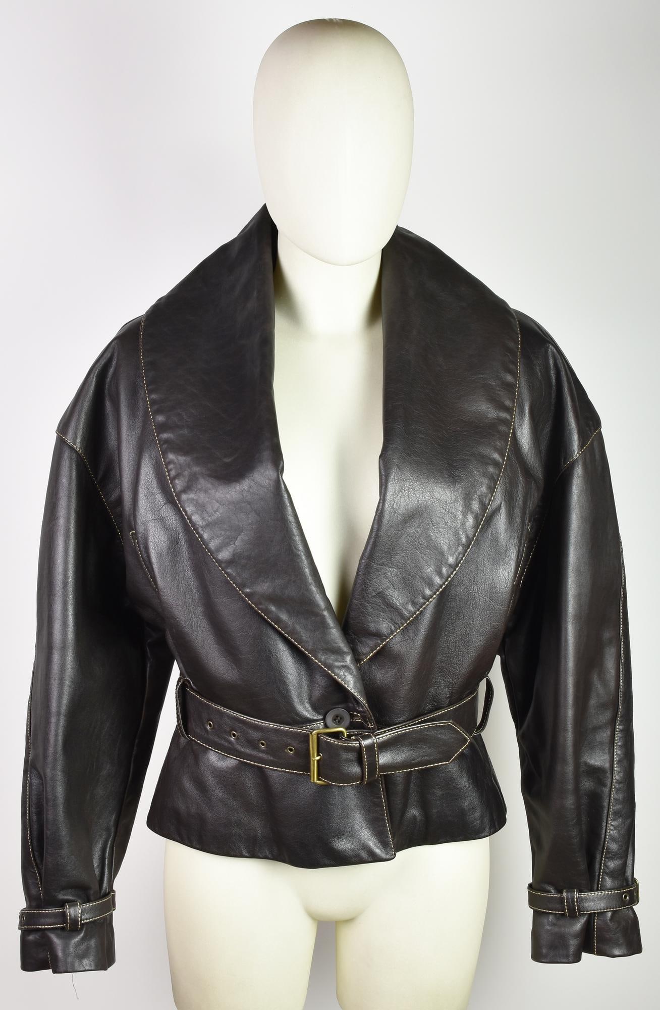 Byblos LEATHER JACKET: ByblosLEATHER JACKETDESCRIPTION:Dark brown leather jacket with contrast stitching. Features a waist belt, decorative straps on the cuffs, and two flap pockets. Quilted viscose lining. Size 46. Made in