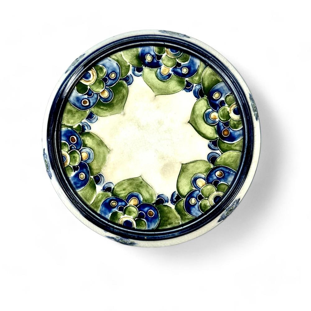 ART NOUVEAU William MOORCROFT Macintyre Florian Teapot Trivet Blue c1900: Up for sale is a beautiful William Moorcroft blue on green florian tea trivet stand dating back to circa 1900. It features a MacIntyre Burslem marking on the bottom and measures 6.5" in diameter.Condi