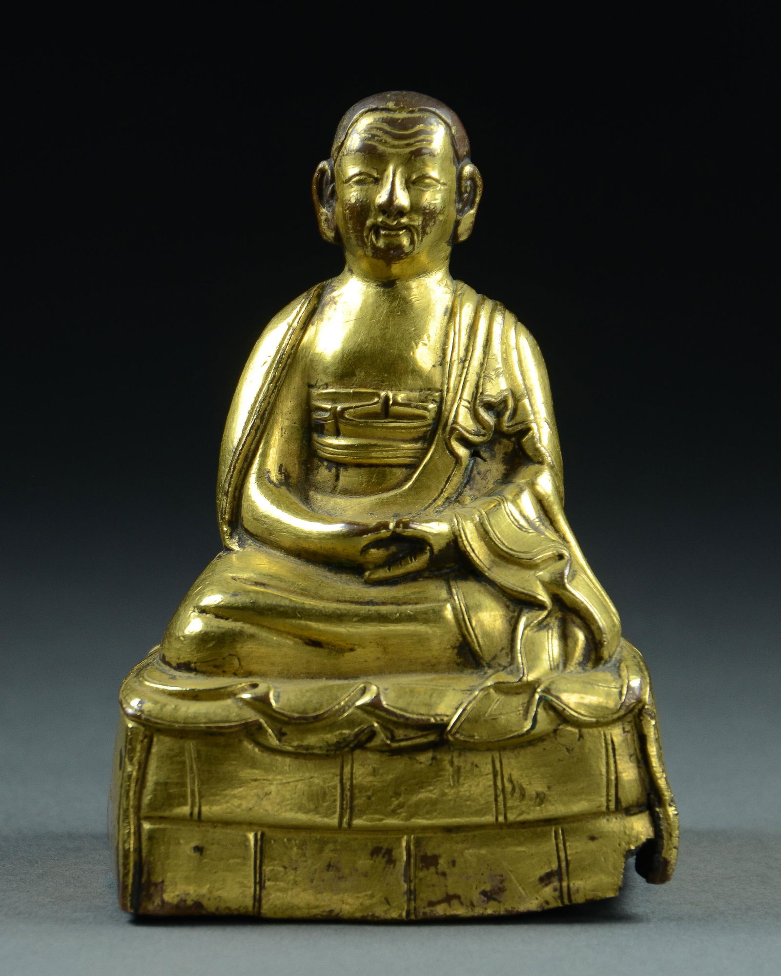 TIBETAN GILT BRONZE SEATED FIGURE OF A LAMA, 17/18TH C. (1 of 5)