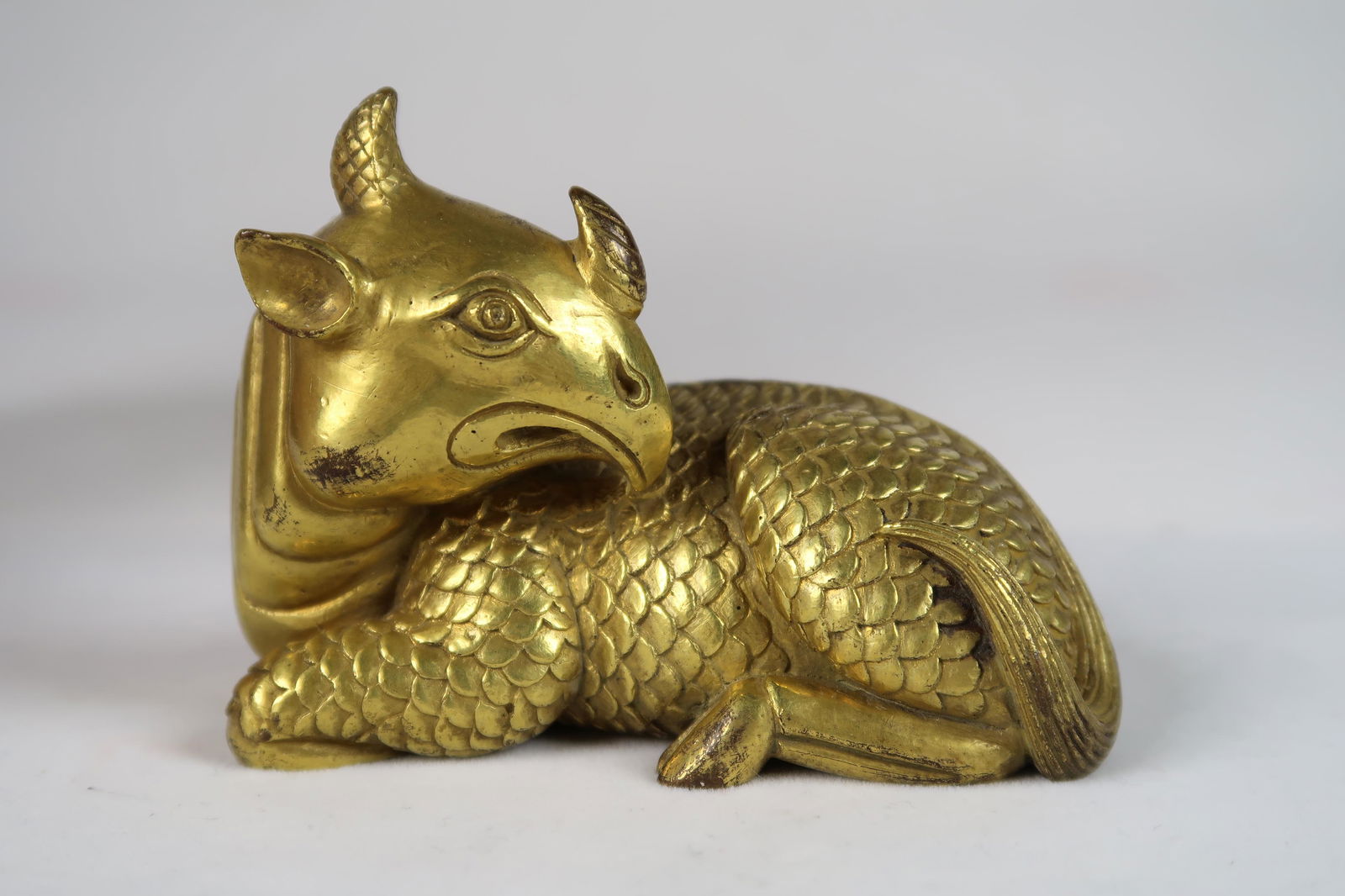 A GILT-BRONZE 'MYTHICAL BEAST' PAPERWEIGHT (1 of 5)