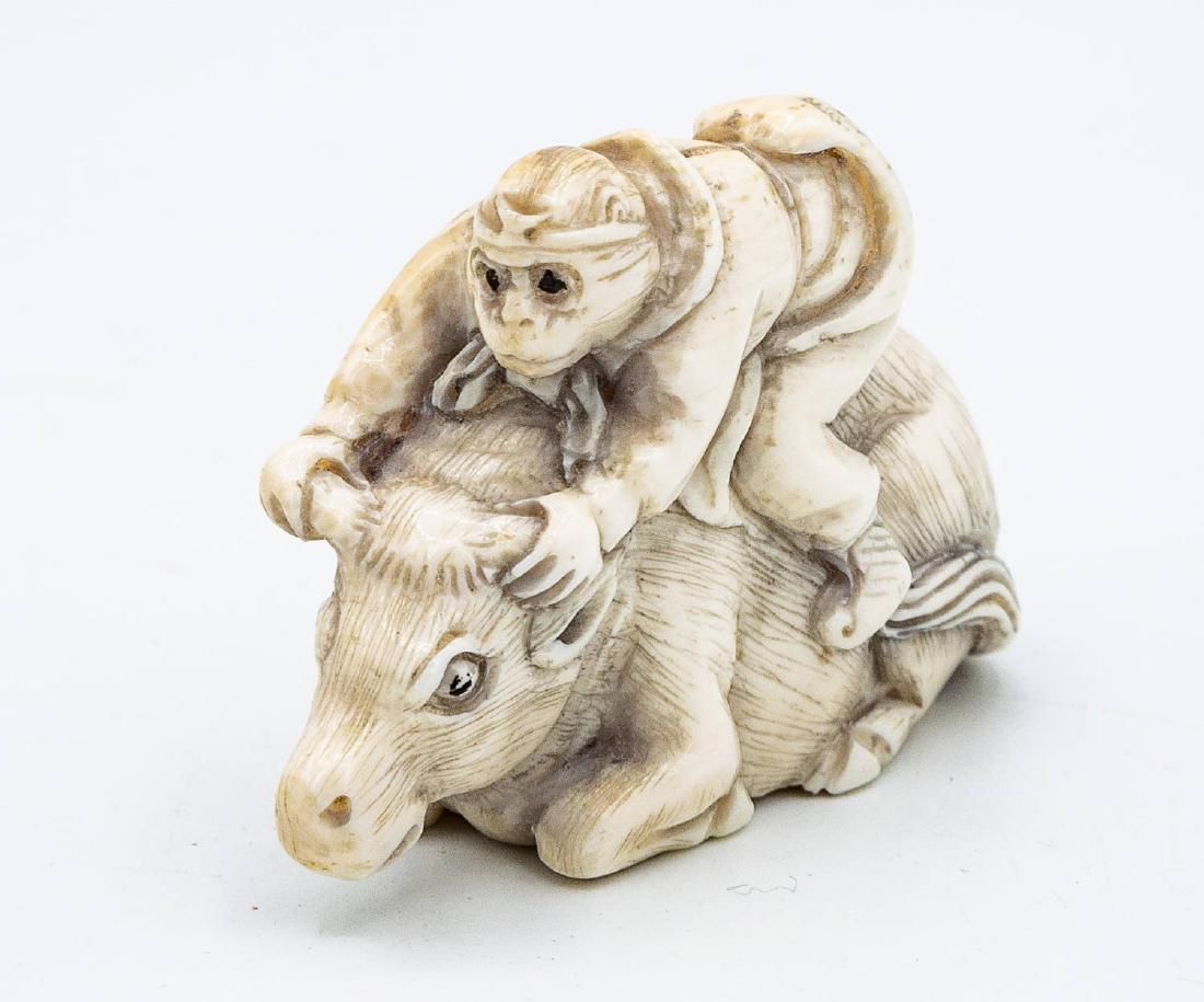A Fine Meiji Period Carved Katabori Netsuke of a: A Fine Meiji Period Carved Katabori Netsuke of a Monkey Riding a Bull, 1868-1912 Description: Fully marked, maker's mark (on the underside). 5 x 3.7 cm