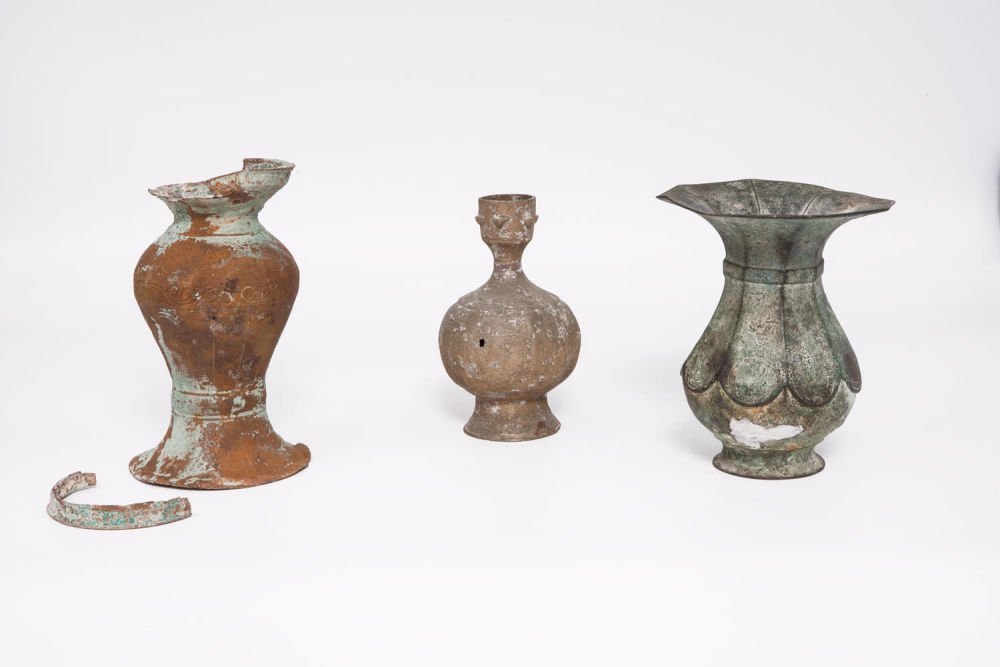 Three Khorasan Bronze Vases, Iran, 11th Century: Three Khorasan Bronze Vases, Iran, 11th Century Including: Baluster form, raised on a circular support with a wide outturned mouth. engraved with geometric motifs. Height: 14 cm A small vase with a bu