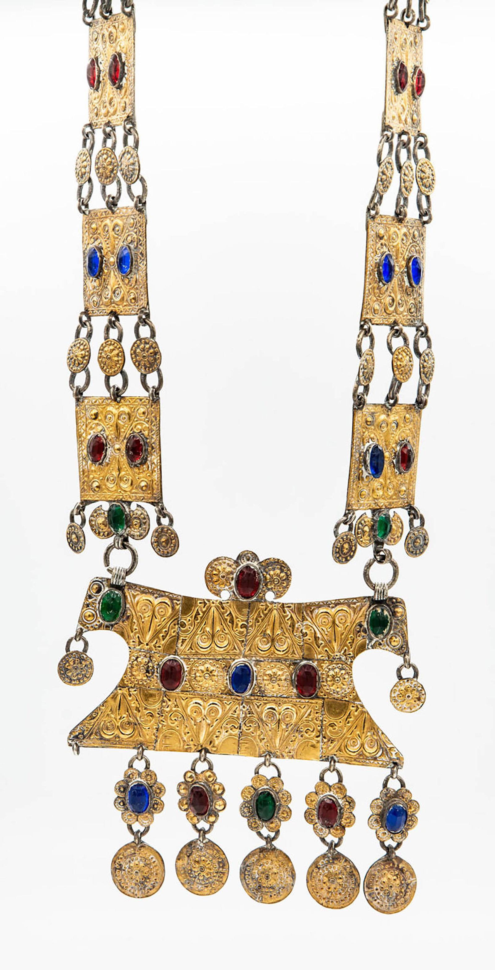 A Magnificent Yomut Silver Gilt Breast Ornament,: A Magnificent Yomut Silver Gilt Breast Ornament, Uzbekistan, Mid 19th Century Composed of a large, central element, hammered and embossed with biomorphic motifs and set with colored stuff. Beneath a f
