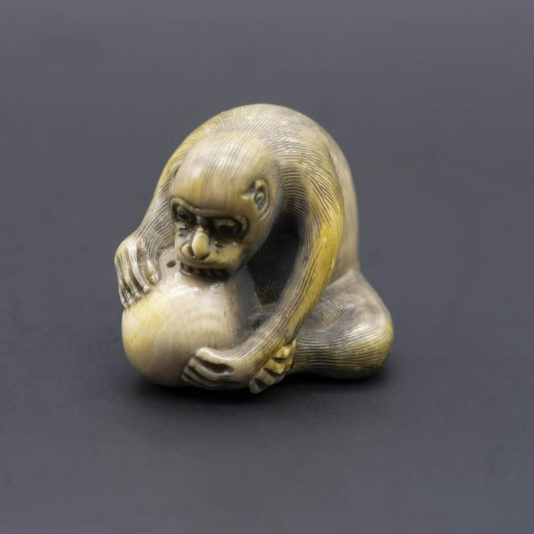 A Fine Carved Netsuke of a Monkey with the Peach of: A Fine Carved Netsuke of a Monkey with the Peach of Immortality, Signed GYOKUSEKI, Early 20th Century Signed. Height: 3.8 cm Condition: For a detailed condition report, please contac