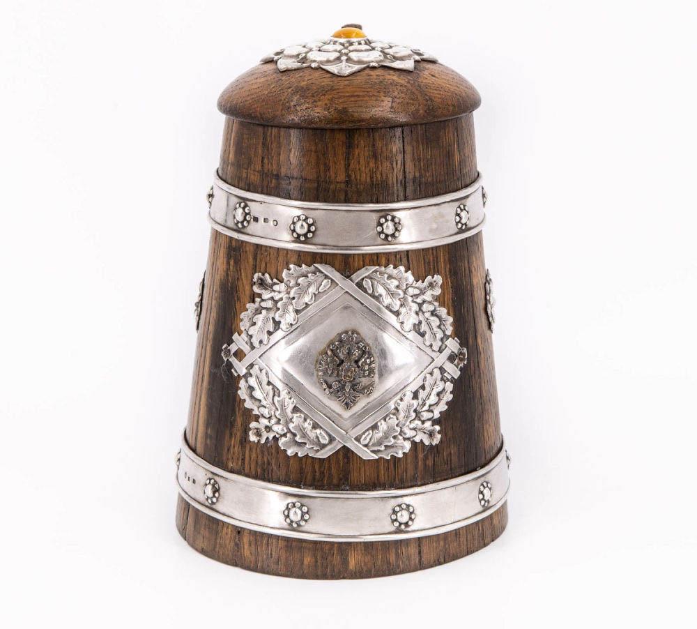 A Silver and Wood Tankard by Richard Lange, Riga,: A Silver and Wood Tankard by Richard Lange, Riga, 1903-1914 Barrel shaped body with decorative silver rings on top and bottom. The front decorated with a silver applied vignette centered by a royal in