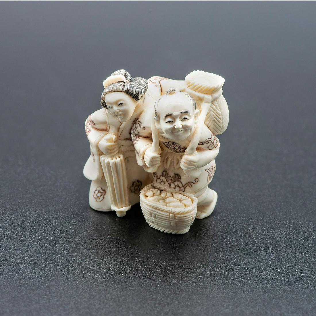A Carved Netsuke of a Couple, Japan, Early 20th: A Carved Netsuke of a Couple, Japan, Early 20th Century Signed (on the underside). Height: 3.8 cm Condition: For a detailed condition report, please contact us at info@hammersite.com