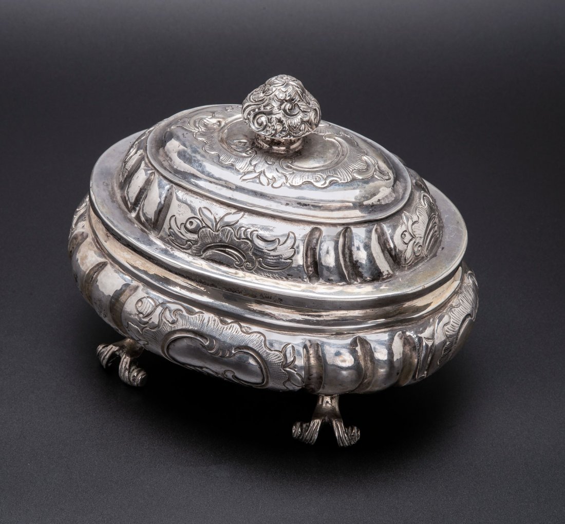 A Rare Silver Etrog Container, Russia, Moscow, 1777: A Rare Silver Etrog Container, Russia, Moscow, 1777 An oval, fluted body, hammered and embossed with rocaille motifs and raised on four supports shaped as curved branches. Topped by a domed lid, simil