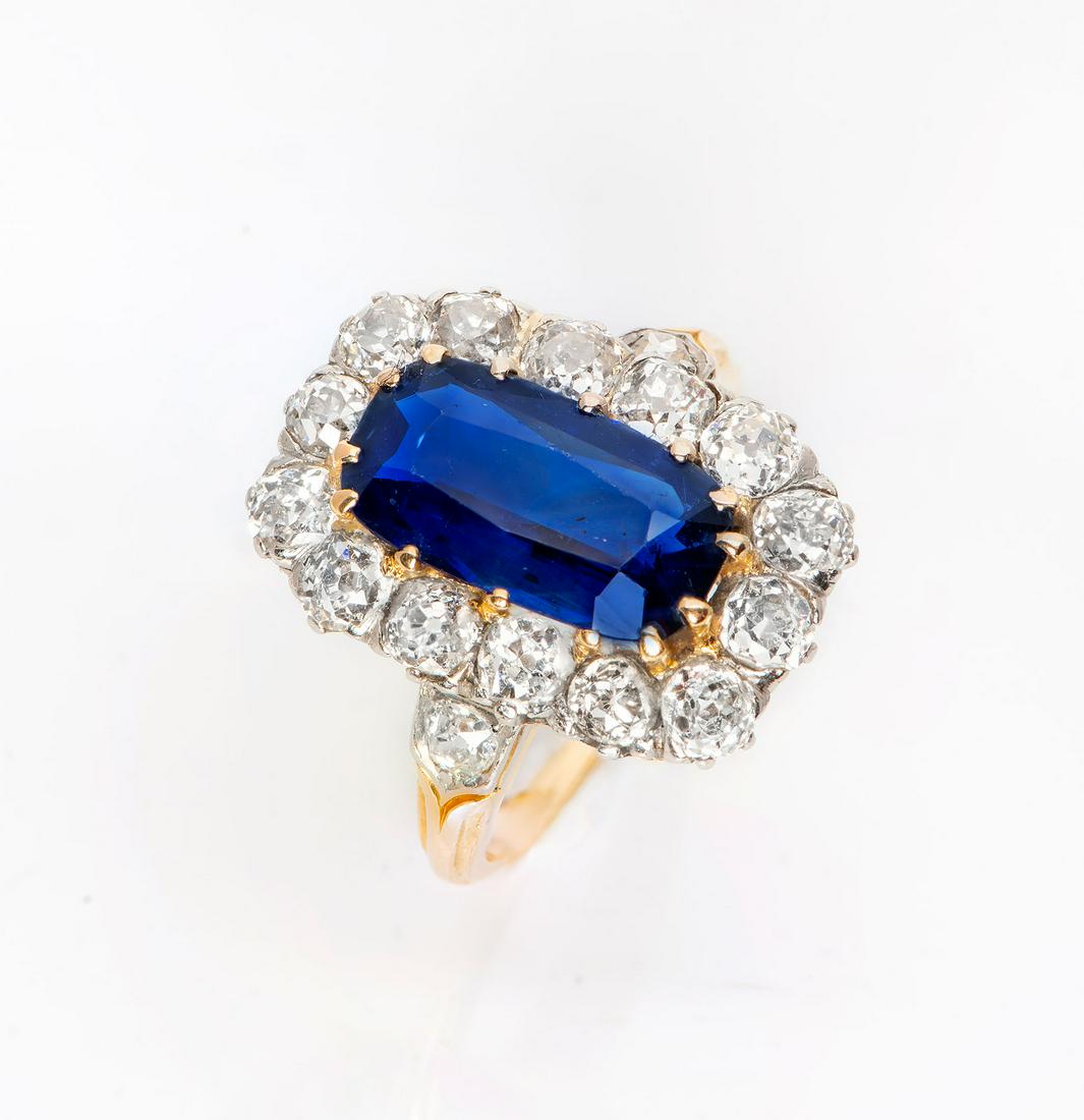 A Fine 18K Gold Platinum Diamond and Sapphire Ring: A Fine Edwardian 18K Gold Platinum Diamond and Sapphire Ring A very fine (approx. 5Ct) emerald-cut sapphire bordered by old-cut diamonds (approx. 3+Ct) and mounted on a thin gold band. Total weight: 7