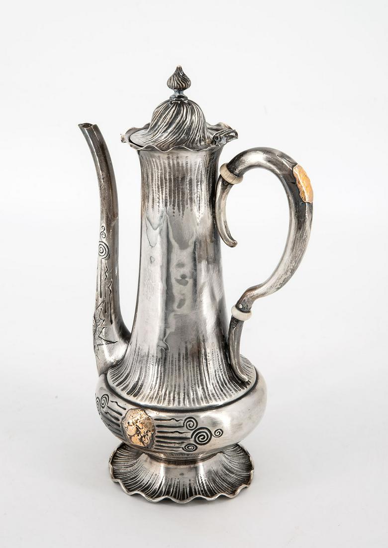 A Shiebler & Co Sterling Silver and 14K Gold Coffee: A Shiebler & Co Sterling Silver and 14K Gold Coffee Pot, USA, ca 1880 A round base with a wavy rom surmounted by a bulbous body with a tall neck. The body accented by gold medalion with a profile and 