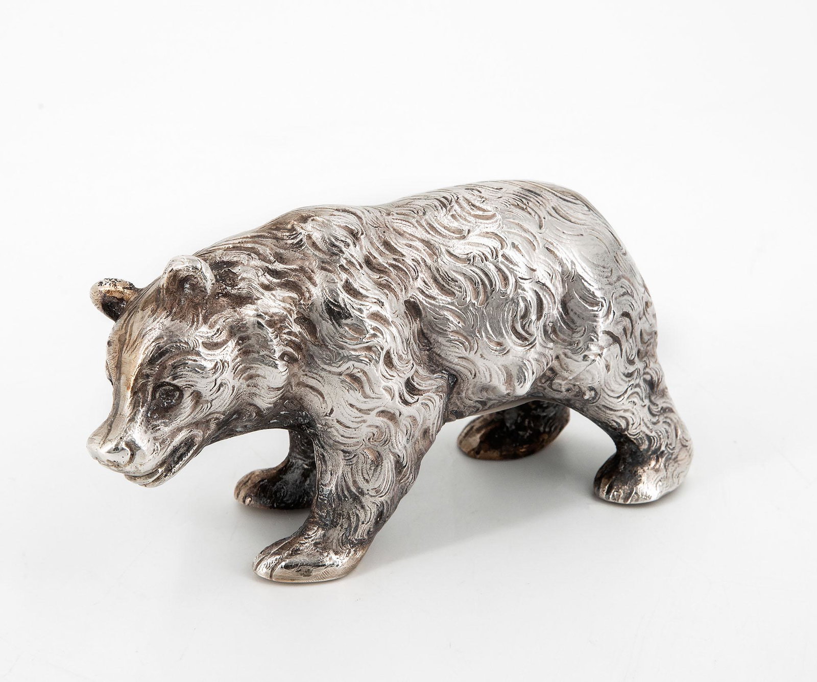 A Silver Figurine of a Bear, Germany, Late 19th Century: A Silver Figurine of a Bear, Germany, Late 19th Century Finely reticulated and engraved. Fully marked (on the underside). Length: 13.5 cm; height: 7 cm; weight: 255 gr Condition: For a detailed condit